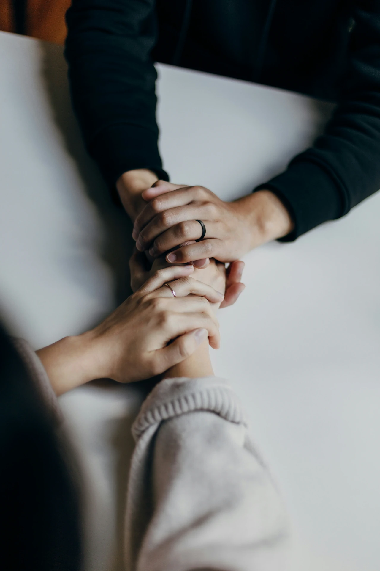 A couple holding hands from across a table